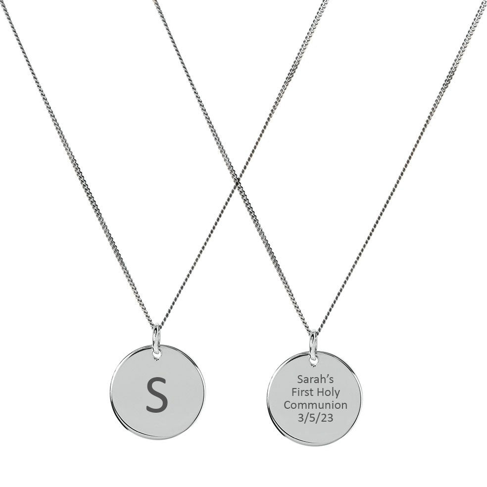 Silver disc pendant engraved with S on front and 'First Holy Communion' on back