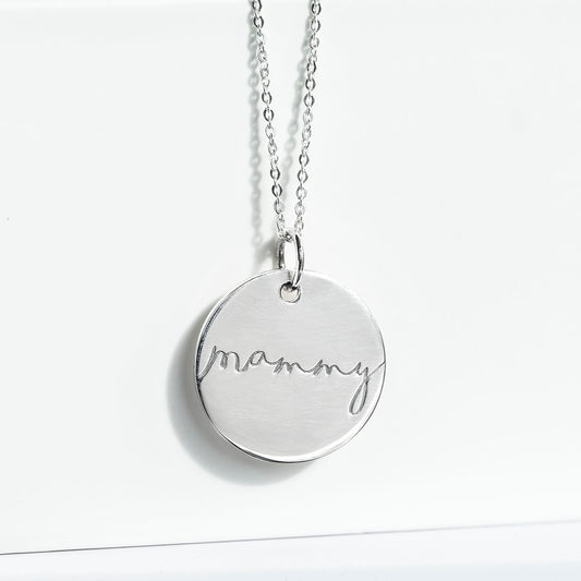 Silver disc pendant on a satellite chain engraved with 'mammy'